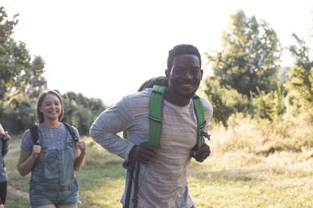 The young people are having fun while walking in the forest