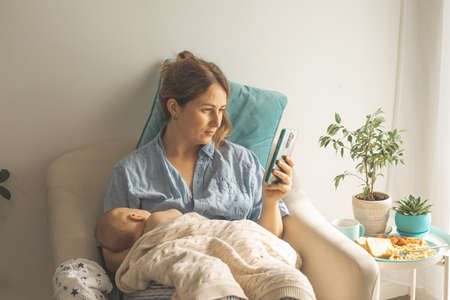 Comfortable and tranquil breastfeeding in cosy armchair at home