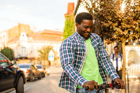 The young man with a scooter is posing in the cityの写真素材