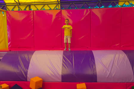 The exhausted and happy little boy in the trampoline parkの写真素材