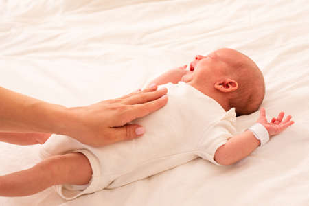 Mother is doing belly massage for newbornの写真素材