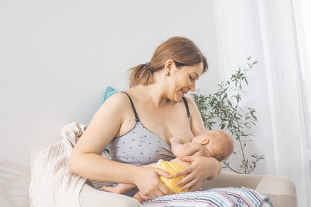 The young mom wants to breastfeed her newborn babyの写真素材