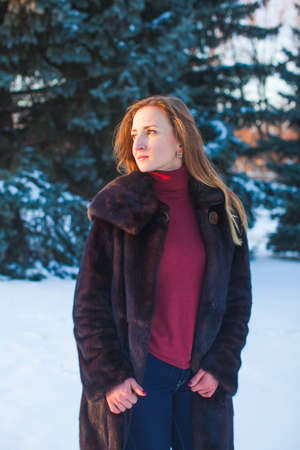 Portrait of a happy adult woman outdoors in winterの写真素材