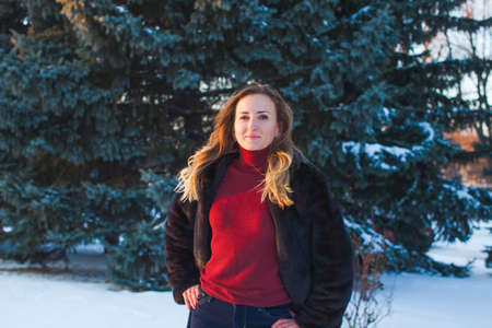 Portrait of a happy adult woman outdoors in winter