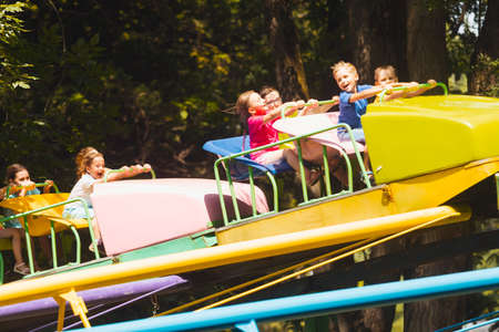 The children experience great emotions of roller coaster ridingの写真素材