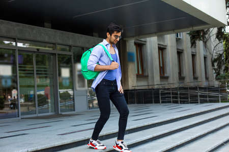 The confident student leaves the university buildingの写真素材