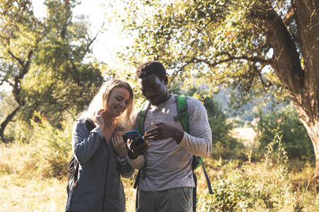 The young couple are looking for a path in the forestの写真素材