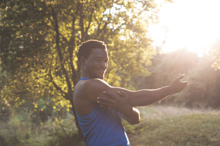 The strong young man have a workout in the parkの写真素材