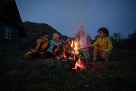 Children after hiking have a picnic - group of happy friendsの写真素材