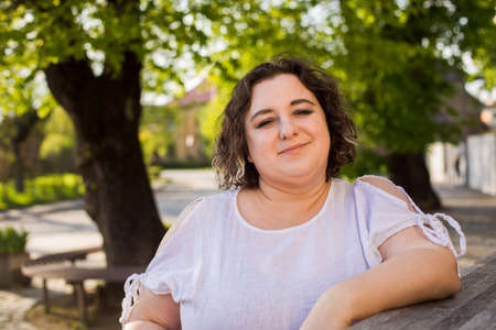 Plus size woman relaxing at outdoors cafeの写真素材