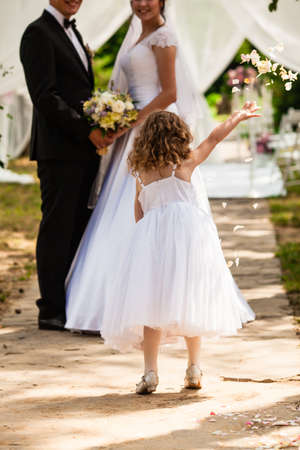Wedding flying rose petals from kids at ceremonyの写真素材