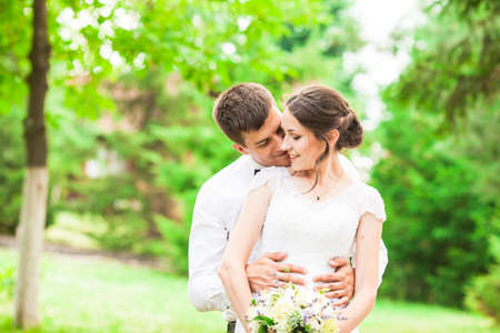 Kissing couple at the wedding ceremony outdoorsの写真素材