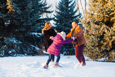 The happy family while are walking in the winter parkの写真素材