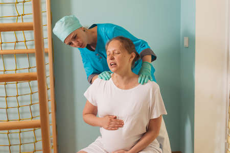 Woman gives birth at hospital, have a contractionの写真素材