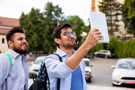 The joyful group of multiethnic students taking a selfie outdoorsの写真素材