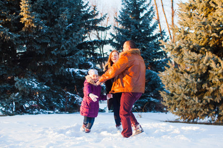 The happy family having fun outdoors in winterの写真素材
