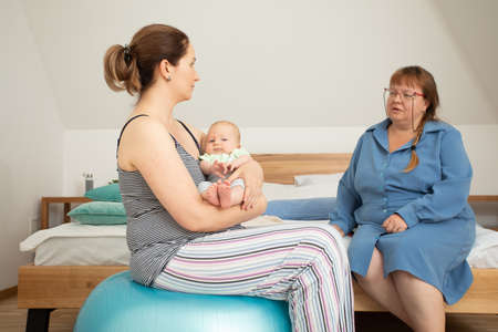 Breastfeeding consultant supports young mother to overcome problemsの写真素材