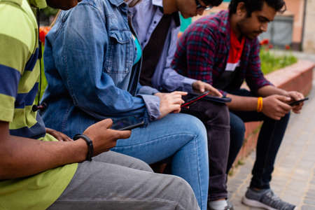 Closeup womans and mens hands holding smartphonesの写真素材