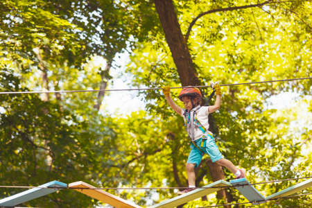 The cute preschooler are playing in the adventure parkの写真素材