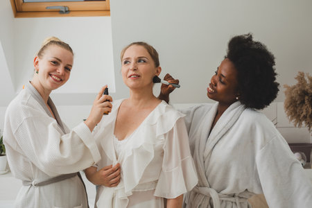 The happy girlfriends at the spa beautify each otherの写真素材