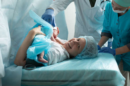 Mother holds newborn baby in the hospitalの写真素材