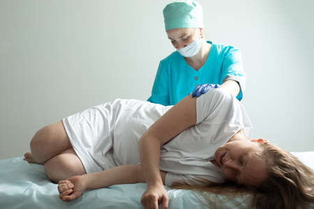 Doctor process epidural nerve block for pregnant womanの写真素材