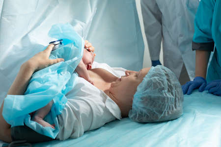 Mother holds newborn baby in the hospital
