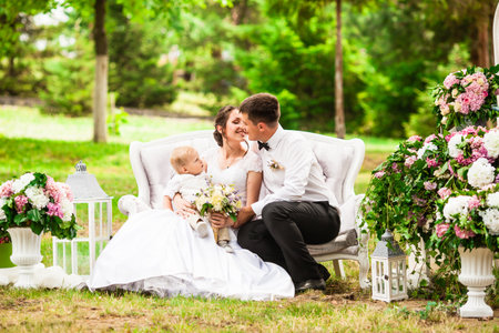 Happy wedding couple at the outdoor wedding decorの写真素材