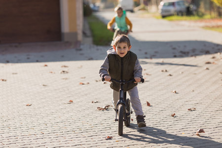 Boy at the bycicle walks at the streetの写真素材