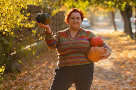 Portrait of happy smile woman with pumpkins in hand.の写真素材