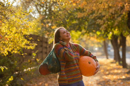Portrait of happy smile woman with pumpkins in hand.の写真素材