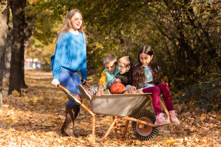 Mother have fun time with kids, use garden wheelbarrowの写真素材