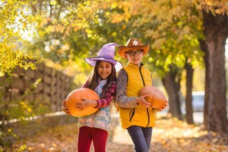 Kids picking and carving pumpkins at country farmの写真素材