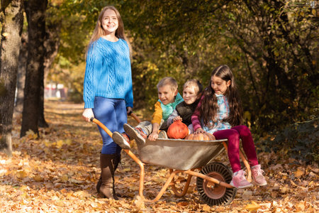 Mother have fun time with kids, use garden wheelbarrowの写真素材