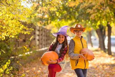 Group of little kids enjoying harvest festival celebration at pumpkin fieldの写真素材