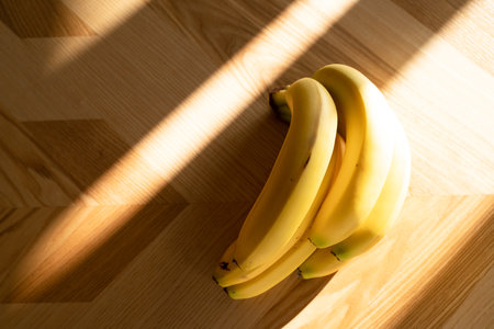 Ripe bananas bunch on the wooden backgroundの写真素材