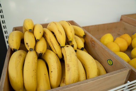 Fresh bananas in wooden boxes on big marketの写真素材