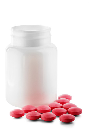 Medical pink pills and white bottle on white isolated background. Concept of healthcare and medicine.の写真素材