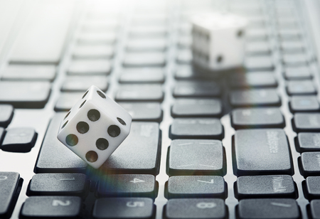 Dice on laptop computer keyboard. Ð¡oncept of online gambling and online casino. Creative idea...
