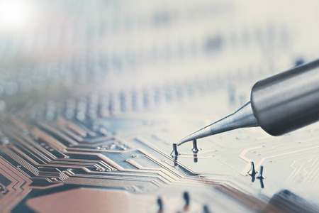Work in progress. Soldering of electronic circuit board with electronic components. Soldering...