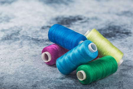 Sewing threads on drums. A lot of colored threads for designers.の写真素材