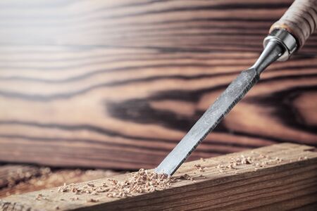chisel cut groove in wooden pine plank. joinery, wood carving , carpenter's skill.の写真素材