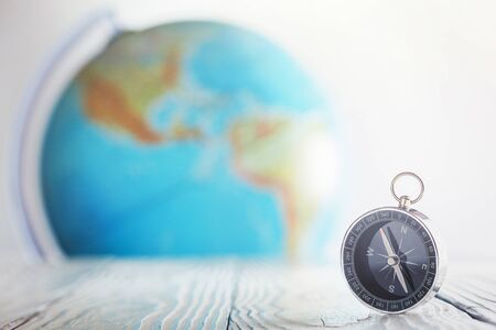Travel compass and earth globus on wooden background. Journey, adventure lifestyle.Road to home.Trip.の写真素材