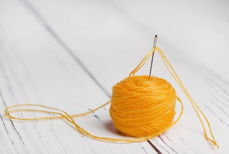 threads and sewing needle on wooden backgroundの写真素材