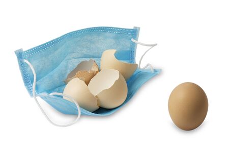 Broken chicken eggs in a medical mask. Dangerous flu virus.