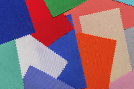 Background from fabric of different colors. Samples of fabric for needlework and creativity.