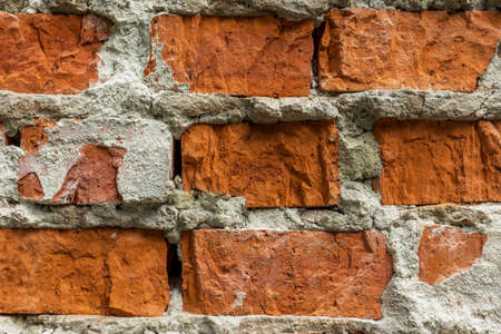 old brick wall with traces, cracks and concrete smudgesの写真素材