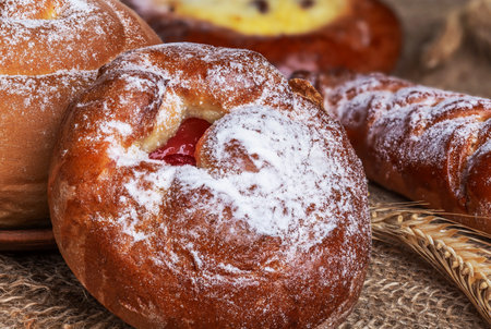 Sweet homemade freshly baked bun on the table. close-up.の写真素材