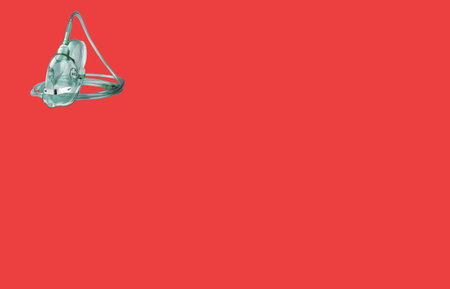 medical oxygen mask on red backgroundの写真素材