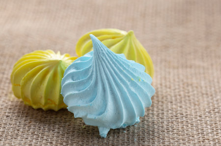 tasty and sweet meringue in white and yellow close-upの写真素材